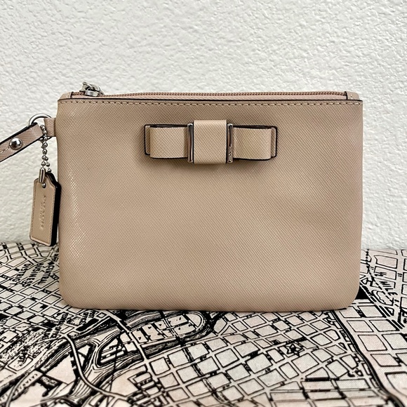 Coach Wristlet with bow Color: Sand/tan 6.25"W x 4.25"H x .25 D - Picture 1 of 6